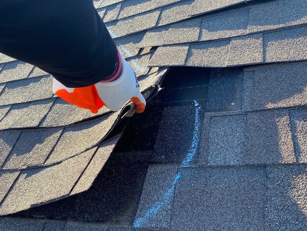 A wind-creased shingle. It lay back down, but the seal is broken.