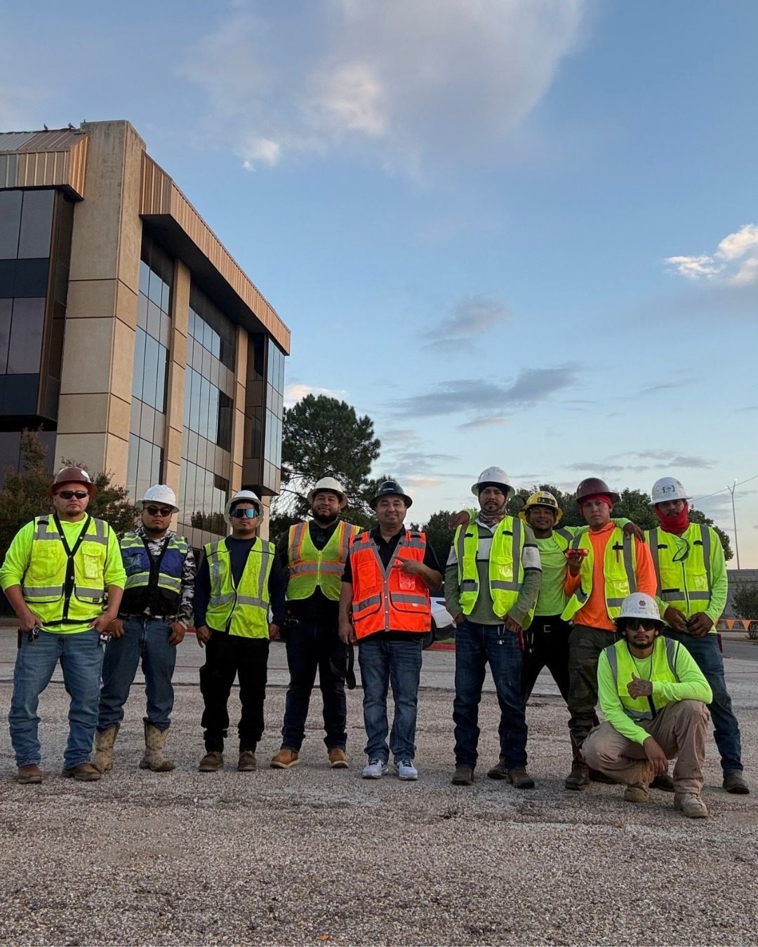 Team members in hard hats and safety vests on a commercial job site